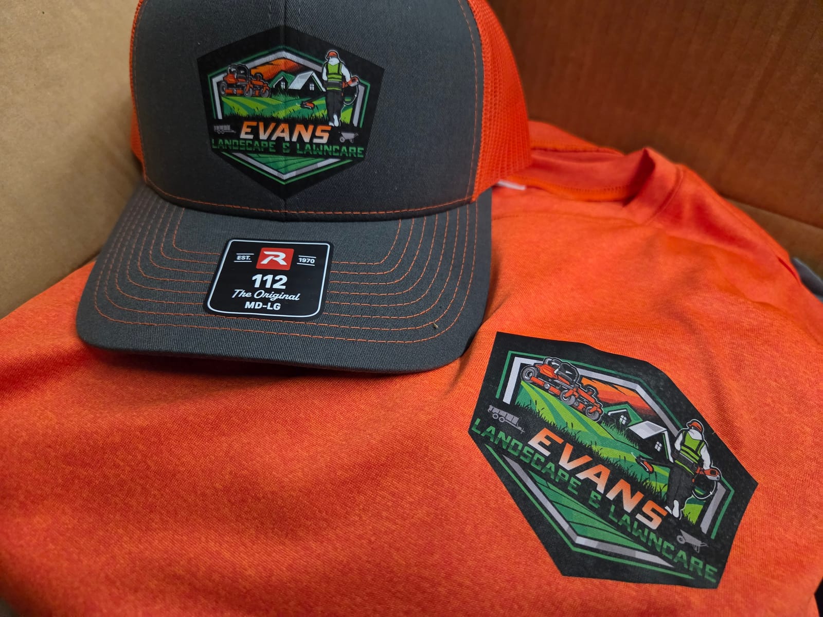 Full-color DTF logo on a trucker hat and t-shirt for Evans Landscape and Lawncare