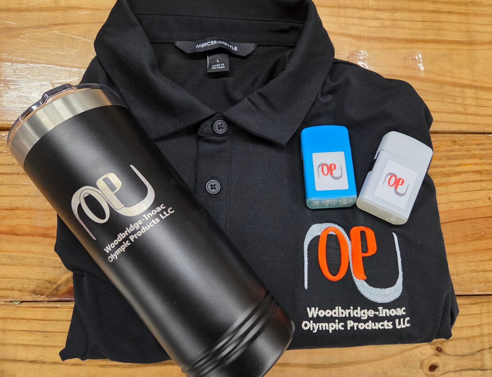 Embroidered polo, engraved tumbler, and branded promotional items for Woodbridge-Inoac Olympic Products